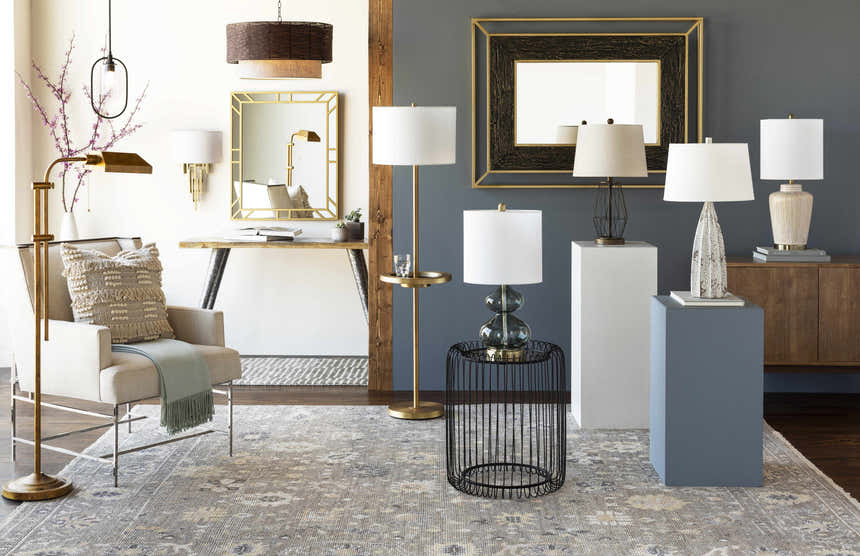 Living room scene with charcoal walls, Kajiado Area Rug in cream, charcoal, and pale blue, and modern furniture. Styleshot