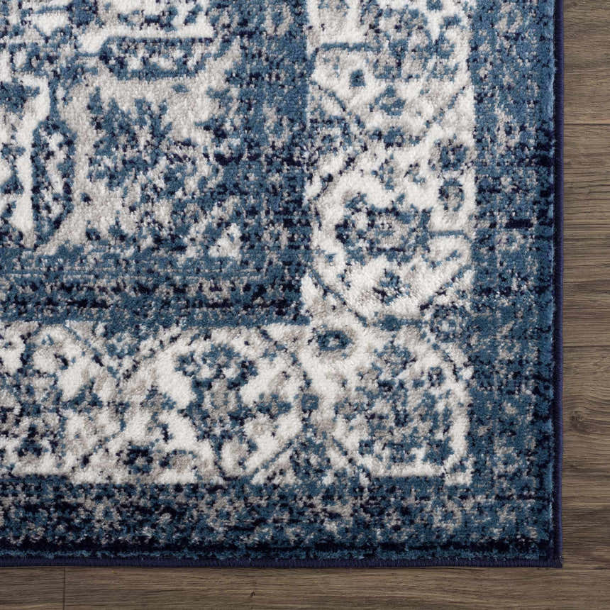 Close up of the blue and navy Billy Area Rug showing its traditional Persian-style pattern. Swatch