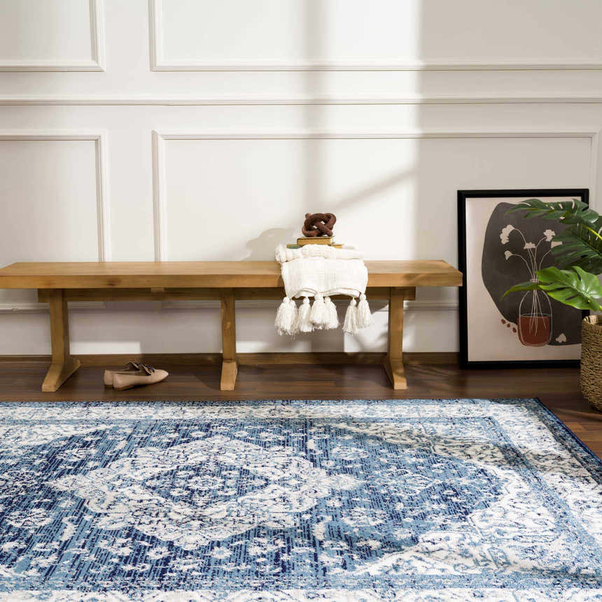 Entryway with blue Billy Area Rug, wood bench, and modern art print. Roomscene-Rectangle