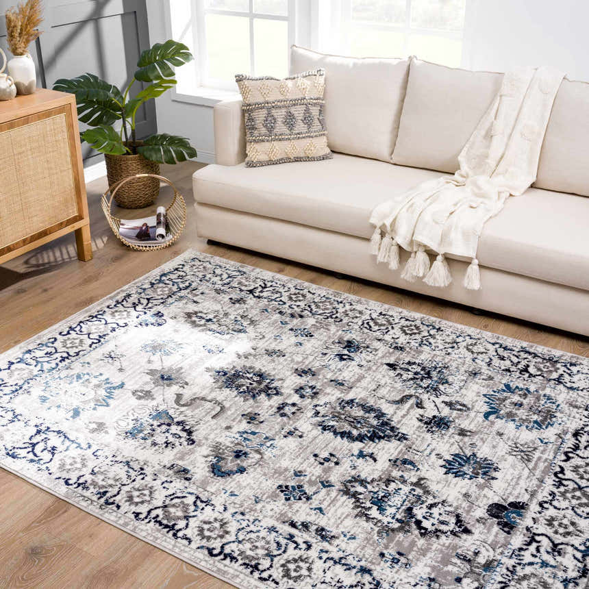 Living room scene with a light sofa and the blue and gray Duena Area Rug. Roomscene-Rectangle