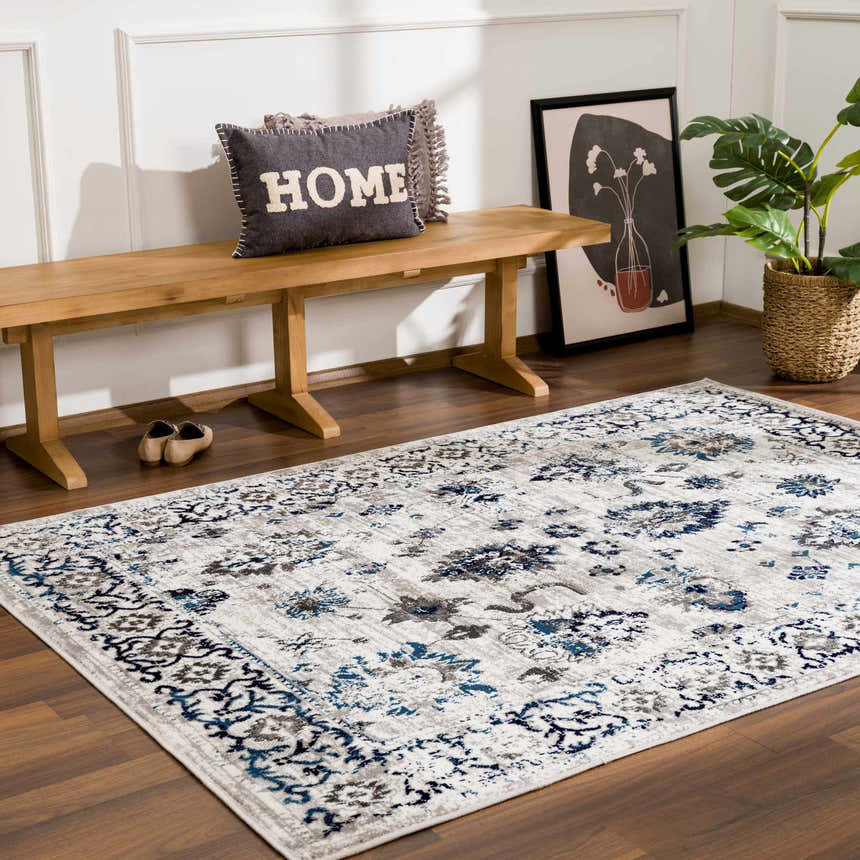 Entryway with wood bench, plant, and blue and light gray Duena Area Rug. Roomscene-Rectangle