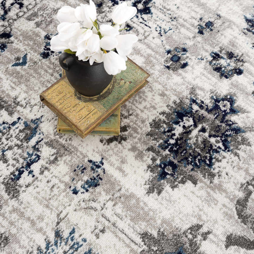 Close-up of the Duena Area Rug: blue and light gray oriental design, traditional vintage style. Styleshot