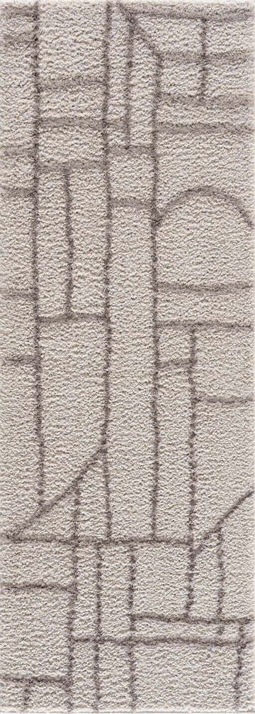 Close-up of the Andia Gray Area Rug. Silver shag rug with a geometric pattern and soft, textured pile. Design-Runner