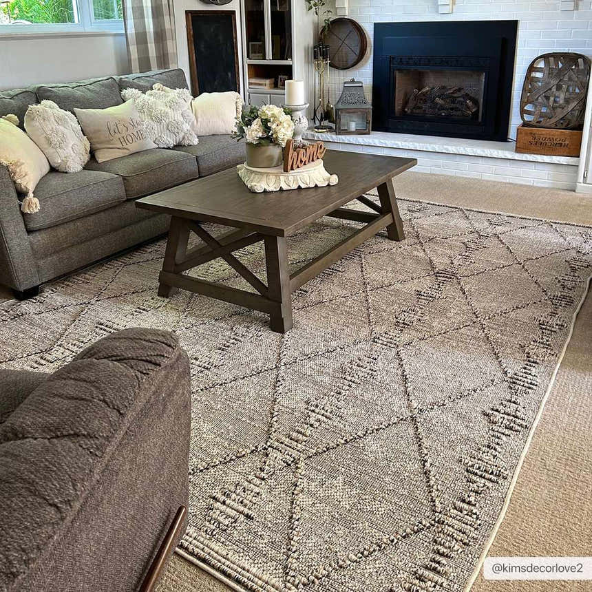Cozy living room with gray sofa and Nyla Bone Indoor Outdoor Rug. The rug features a geometric diamond pattern. Roomscene-Rectangle
