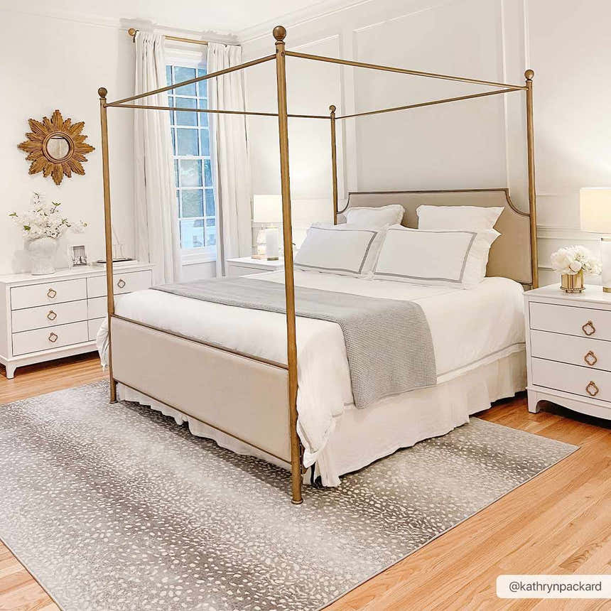 Bedroom with gold canopy bed and Pointblank Black&Gray Antelope Print Rug. Neutral color palette, light and airy feel. Roomscene-Rectangle