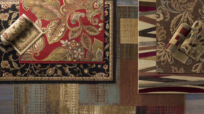 Overhead shot of various rug styles, including the Salona Luxe Black Rug with floral pattern. Styleshot