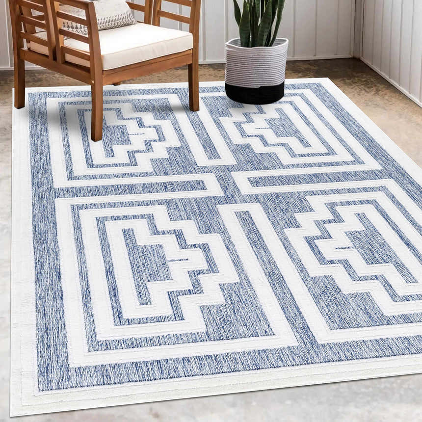 Contemporary patio scene with Yves Blue Outdoor Rug, wood chair, and potted plant. Roomscene-Rectangle