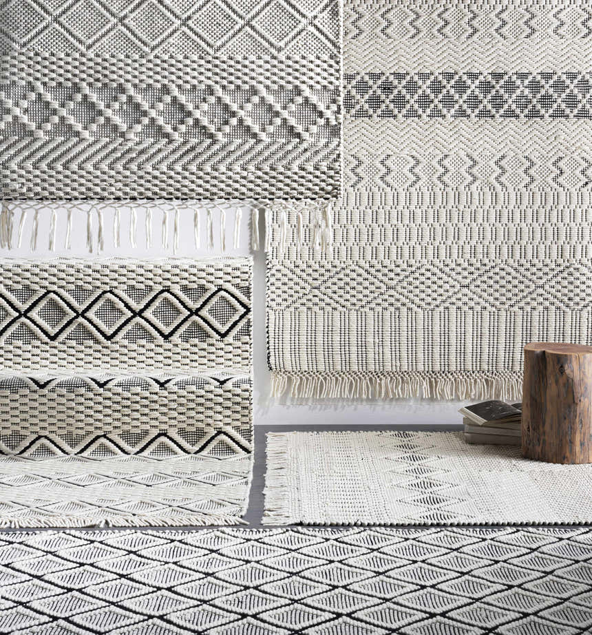 Close-up of hand woven Cobourg Area Carpet in black and cream wool. Geometric patterns and fringe detail. Styleshot