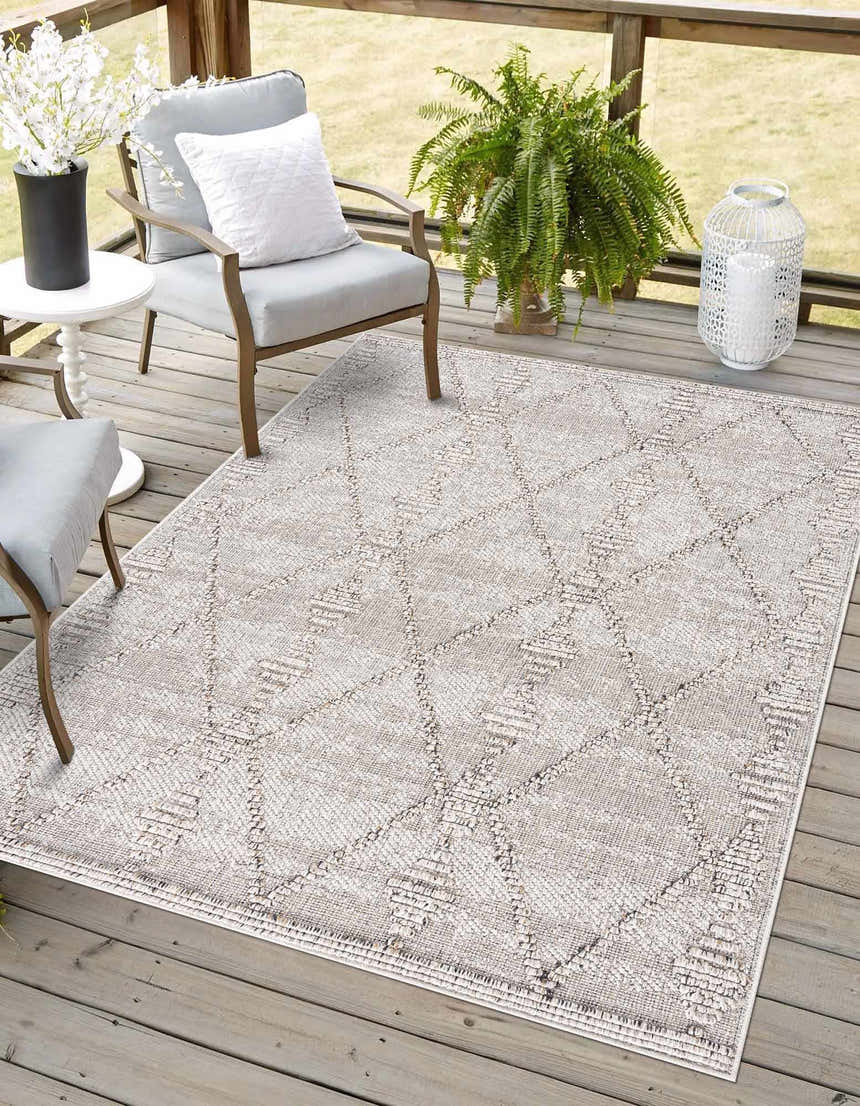 Outdoor patio scene with gray chairs and Nyla Bone Indoor & Outdoor Rug. Contemporary design. Roomscene-Rectangle