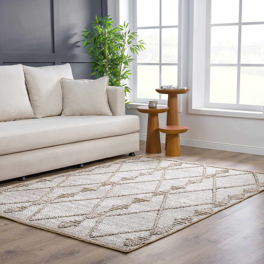 Living room scene with a Nyla Bone & Tan Textured Performance Rug, cream sofa, and wood accent tables. Roomscene-Rectangle