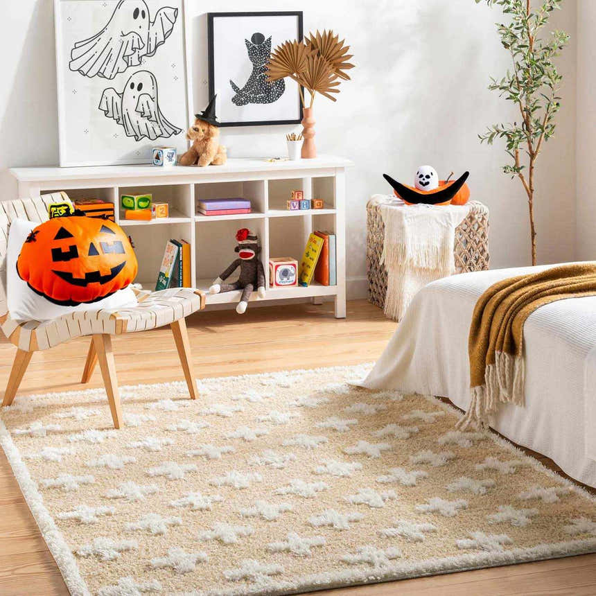 Kids room scene with Satu Beige Area Rug, white furniture, Halloween decor, and light wood flooring. Roomscene-Rectangle