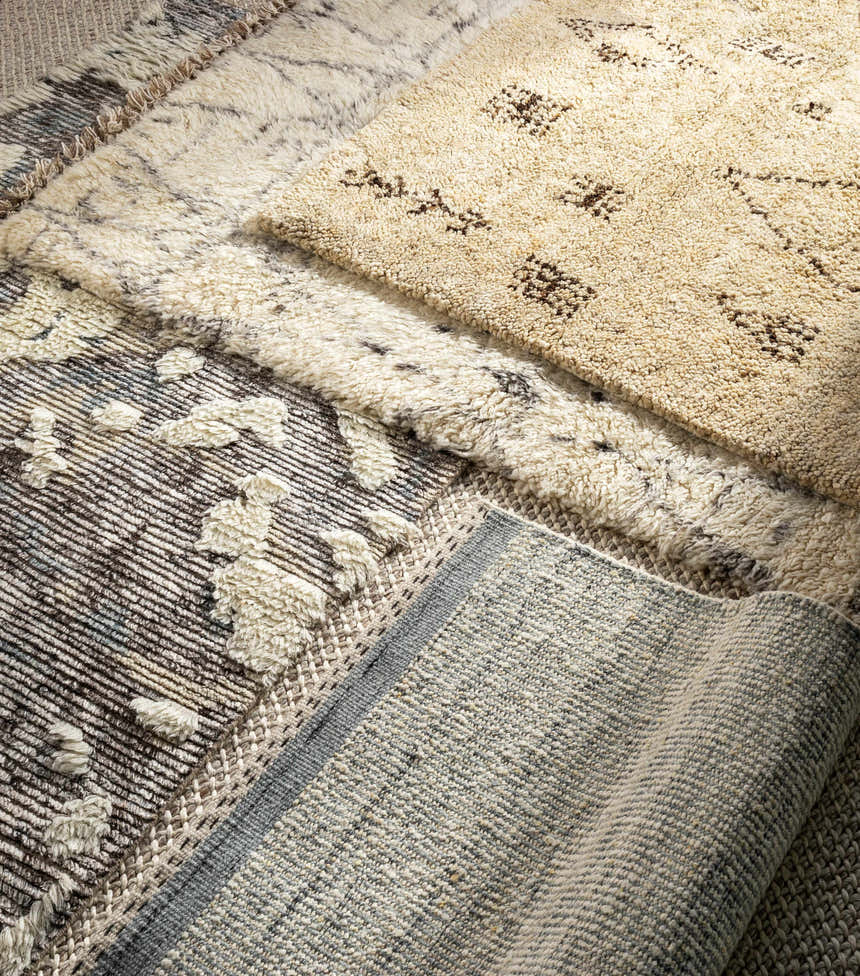 Close-up of Dalaoig Flat Woven Wool Rug showing textures, patterns, and colors: charcoal, cream, denim, light beige, and medium gray. Texture