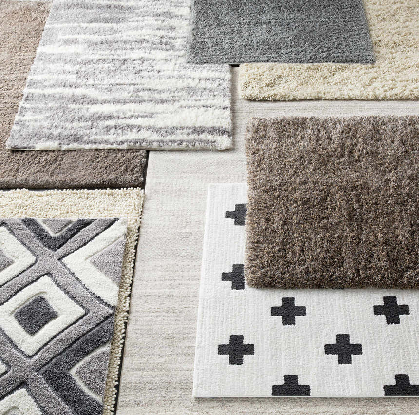 Close-up of various rug textures and patterns, including the Harpursville Area Rug in gray, light brown, and light gray. Styleshot