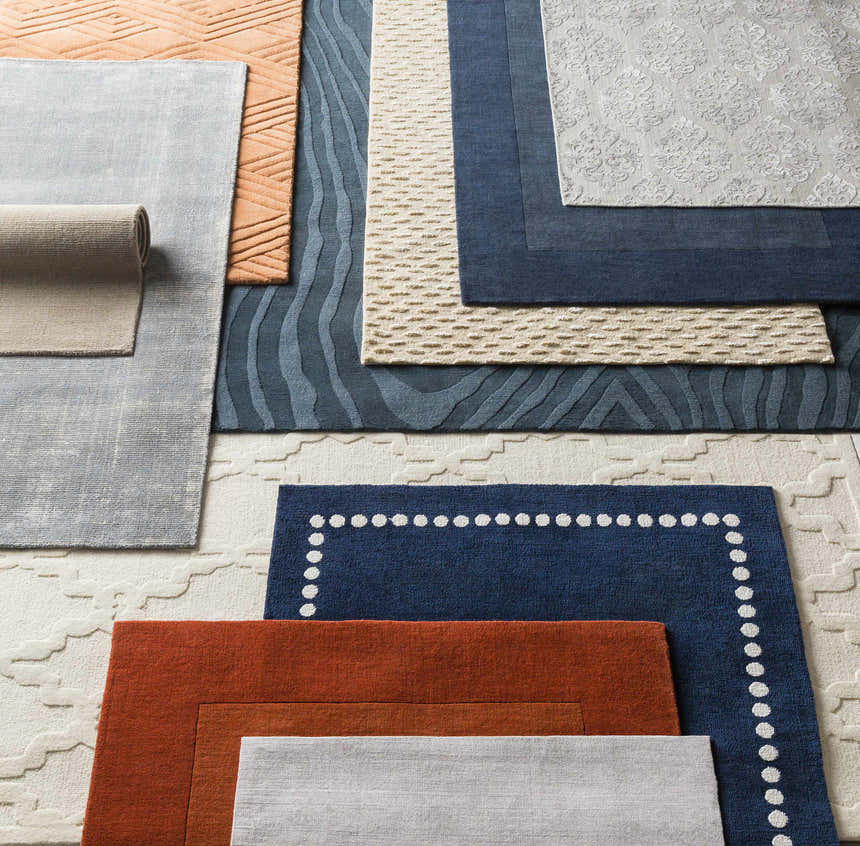 Textured rug swatches, including a Bordered Solid Ink Blue Wool Rug with a white polka dot border. Styleshot