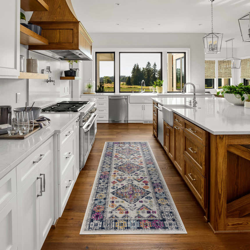 Tigriv Ivory 2312 rug in a bright kitchen. Runner rug with gray, ivory, navy, and orange colors between white and wood cabinets. Roomscene-Runner