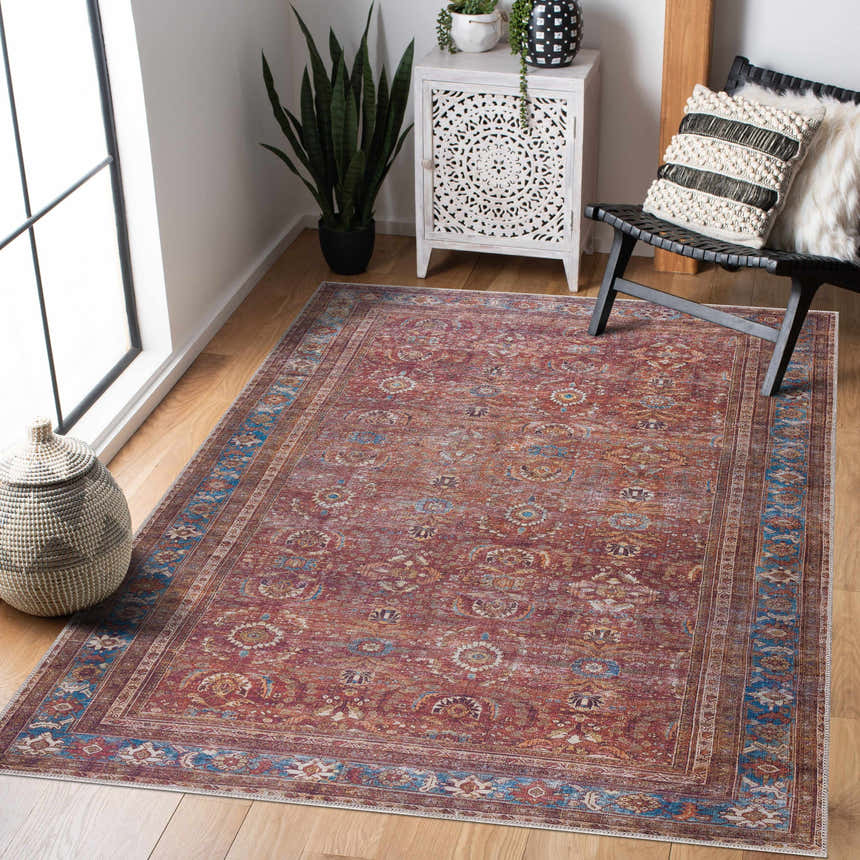 Living room scene with a Rust Baki Traditional Washable Area Rug, black chair, and white cabinet. Warm and inviting. Roomscene-Rectangle