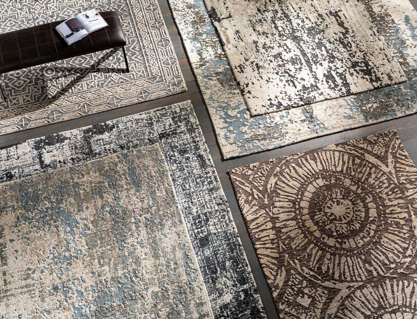 Overhead shot of various rug patterns and textures, including the Dundry Area Carpet in charcoal and cream. Styleshot