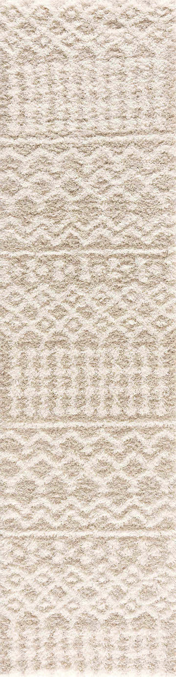 Close-up of the Prompton Cream Plush Area Rug, showcasing its shag texture and bohemian-inspired geometric patterns. Design-Runner-2773