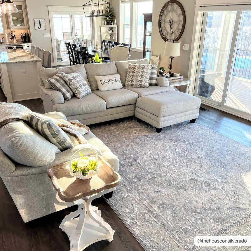 Bright living room with gray sectional sofa and Ulubey Distressed Gray rug. Farmhouse style with dark wood floors. Roomscene-Rectangle