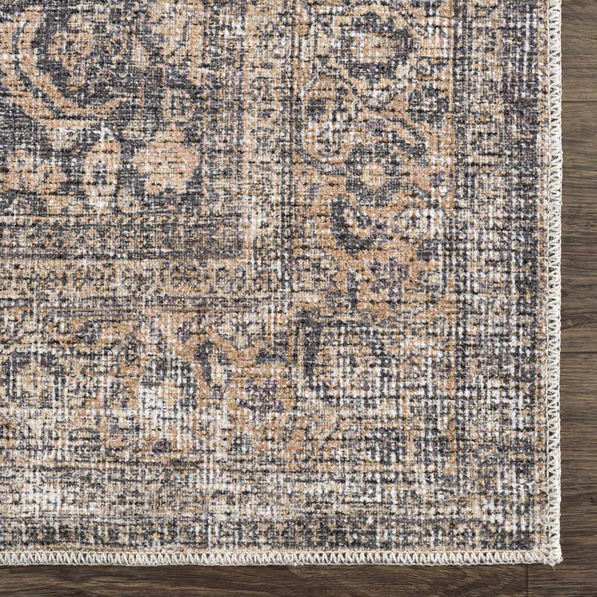 Close up of the Orsin Washable Area Rug showing its traditional design, neutral colors, and machine woven texture. Swatch
