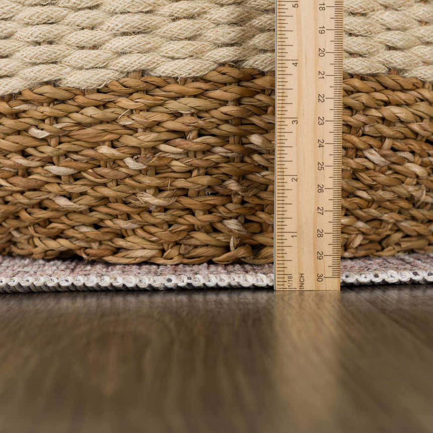 Close-up of the Odele Washable Area Rug showing the rug's edge and pile height with a ruler for scale. Pile