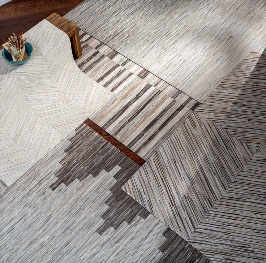 Close-up of Upland Premium Rug. Hand-crafted hair on hide rug in brown, cream and gray with a contemporary pattern. Styleshot