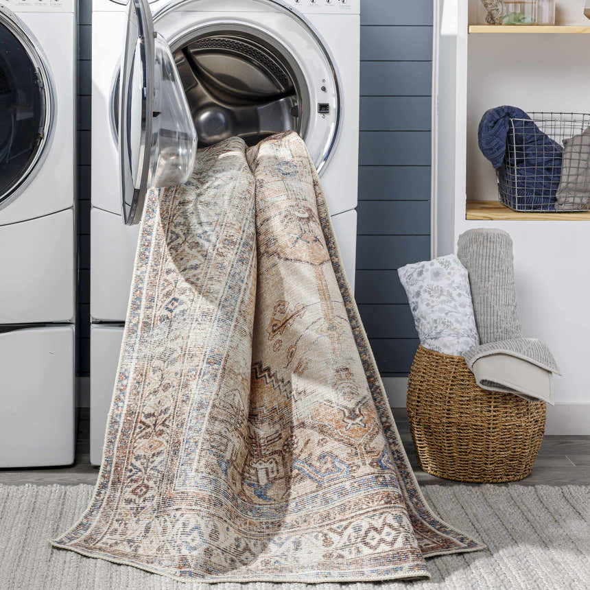 Arncliffe Washable Area Rug in a laundry room being pulled out of a washing machine. Easy clean rug. Washing-Machine