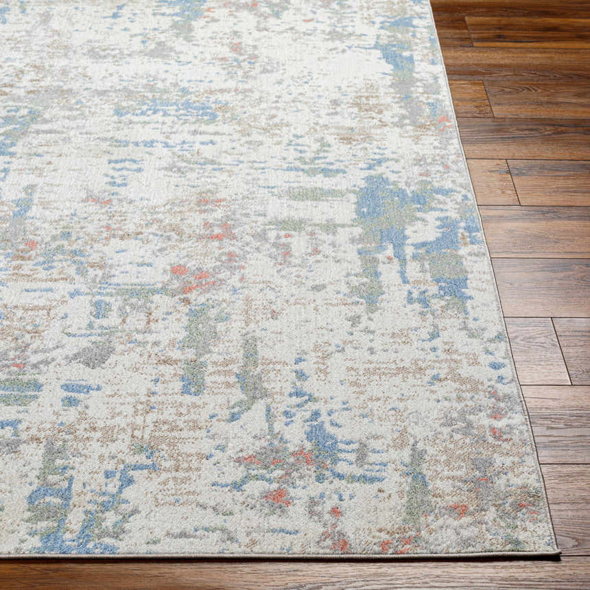 Close-up of Ahava Washable Area Rug. Contemporary style rug with an abstract pattern in white, blue, gray, and coral. Front