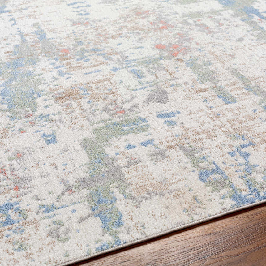 Close-up of the Ahava Washable Area Rug. Neutral background with blue, green, and coral abstract pattern. Polyester texture. Texture