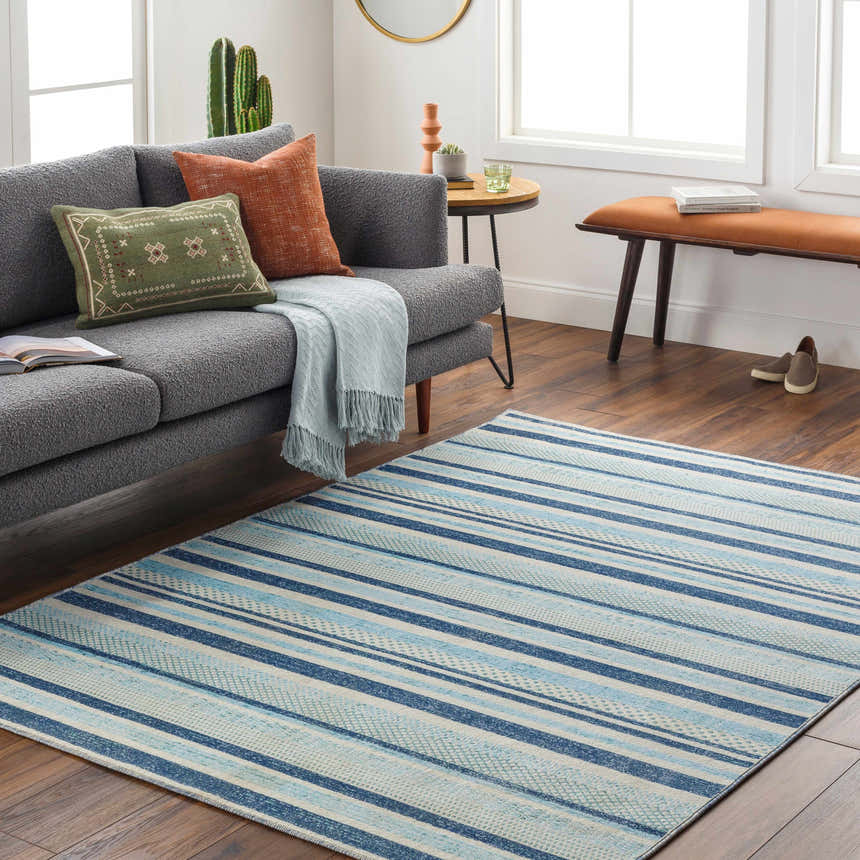 Coastal living room with gray sofa and blue striped Alain Area Rug. Roomscene-Rectangle