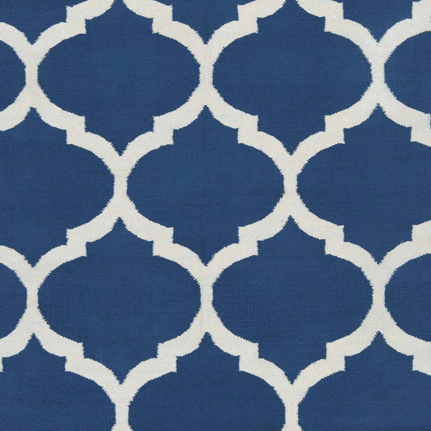 Close-up of the Alcalde Area Carpet. Hand-woven cotton rug with a bright blue background and an ivory quatrefoil pattern. Swatch