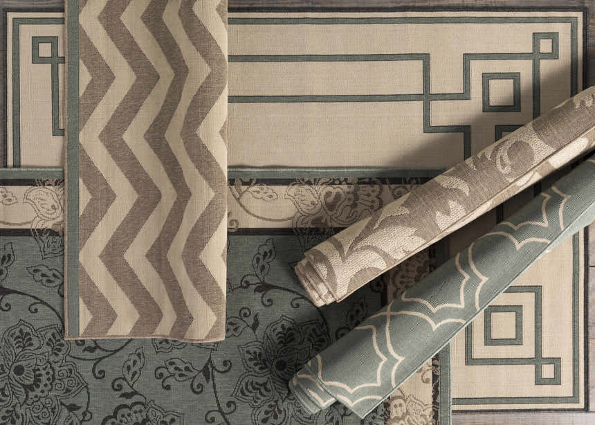 Close-up of Collegeport Area Rug in light beige, brown, and blue with coastal, geometric, and floral patterns. Styleshot