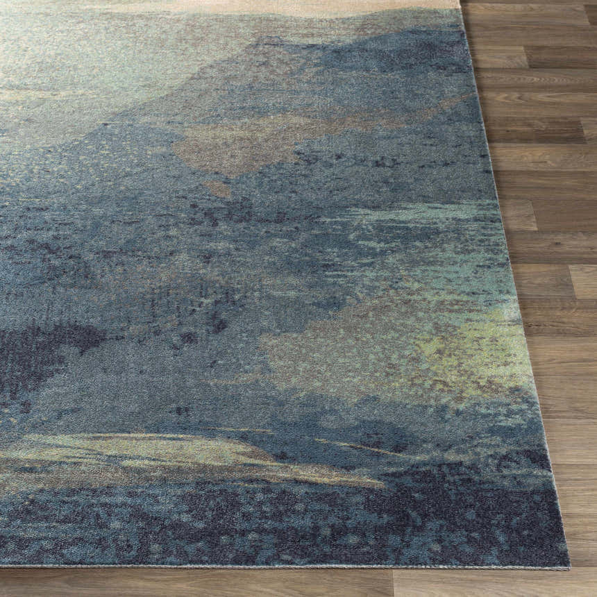 Close-up of the Alvaton Abstract Blue Rug showing its denim, gray, and light blue colors and contemporary abstract design. Front