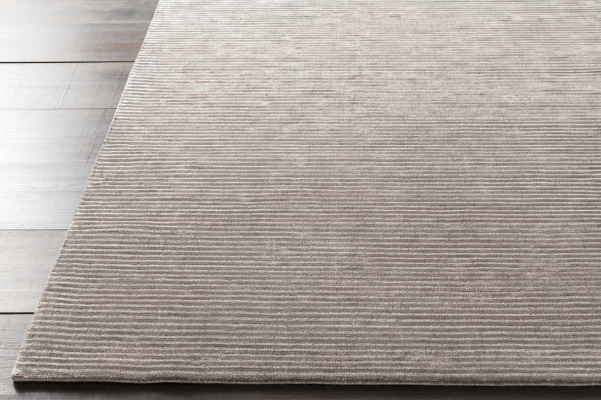 Close-up of the charcoal Angie Area Rug. This hand-loomed rug has a subtle striped pattern and soft viscose texture. Front