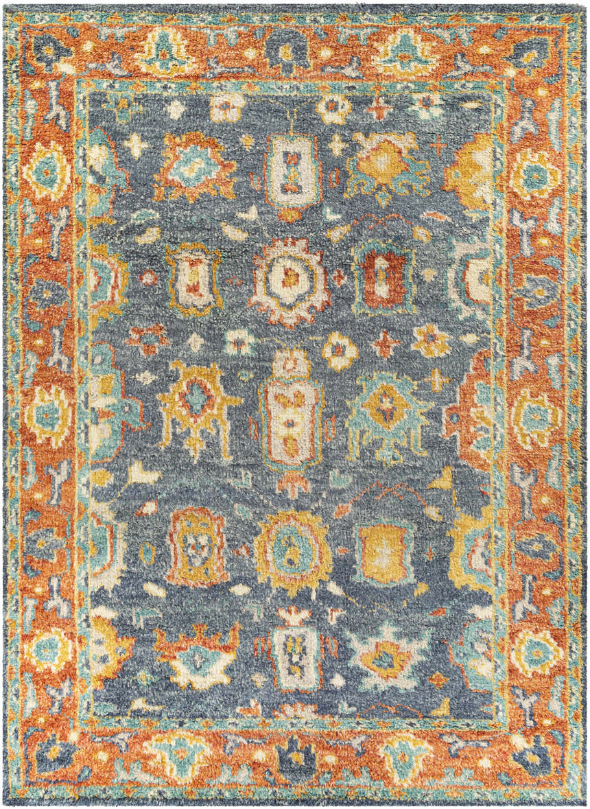 Close-up of the Ankara Premium Wool Area Rug, featuring a traditional design in aqua, orange, and navy. Hand-knotted texture. Design-Rectangle-912
