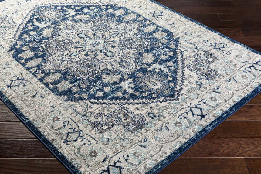Close-up of the Aylsham Area Rug showing its navy, charcoal, and gray traditional design and soft texture. Corner