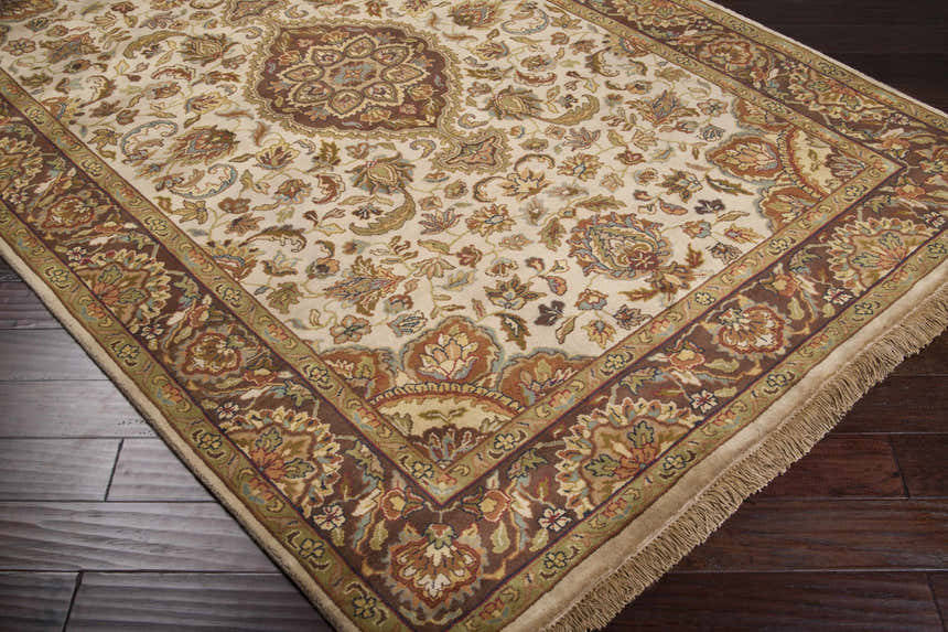 Close-up of the Azalia Premium Wool 8' Round Rug, showcasing its beige, brown, and floral traditional design on dark wood floors. Corner