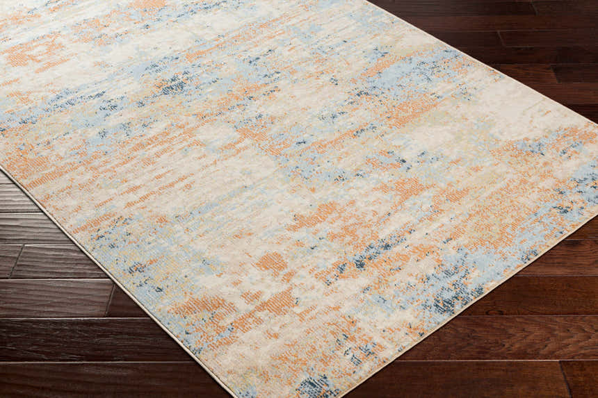 Contemporary Bagulin Area Rug on dark wood floor. Abstract design in cream, blue, and orange. Corner