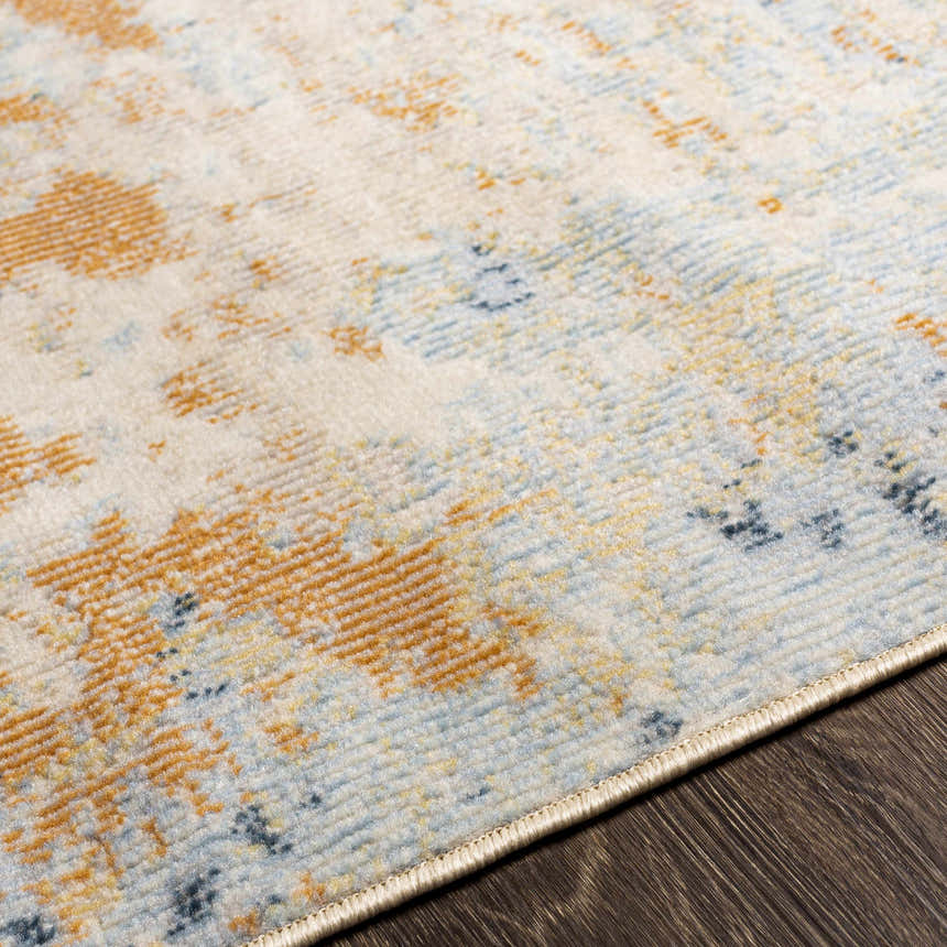 Close-up of the Bagulin Area Rug. Contemporary design with gold, blue, and ivory colors. Designer Pick, suitable for bathroom or kitchen. Texture