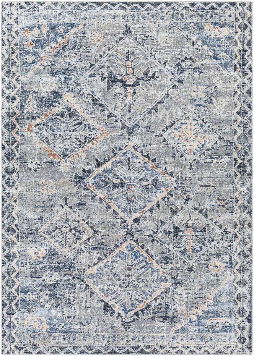 Close-up of the Balamban Area Rug. Bohemian style rug with brick red, cream, denim, gray, light beige, and navy colors. Design-Rectangle-579