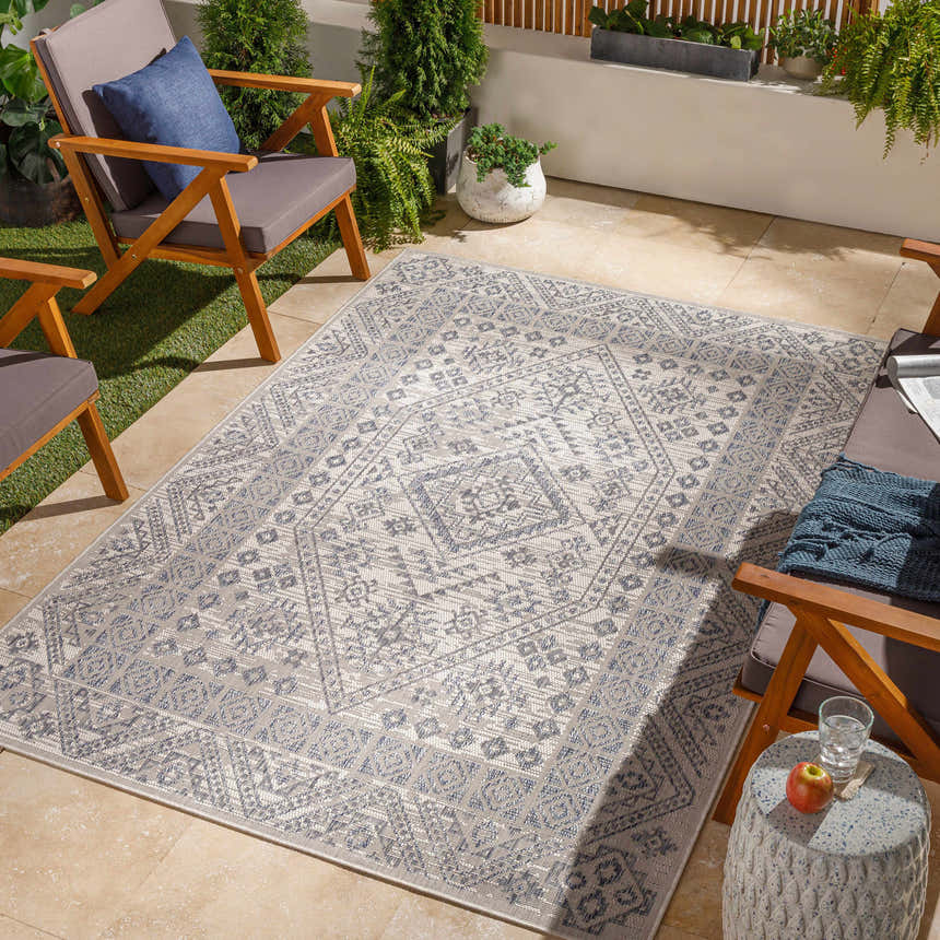 Outdoor patio scene with gray chairs and Balarim Indoor & Outdoor Rug in charcoal and gray geometric pattern. Roomscene-Rectangle
