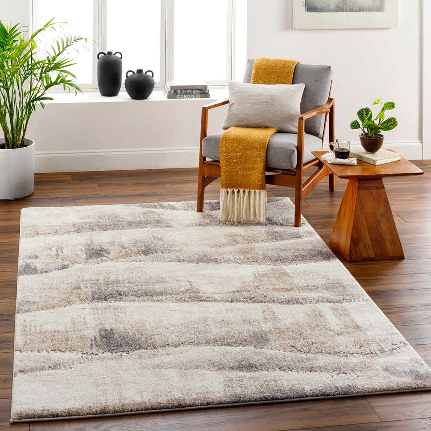 Living room scene with a beige Banji Abstract Waves Area Rug, gray chair, and wood accents. Roomscene-Rectangle
