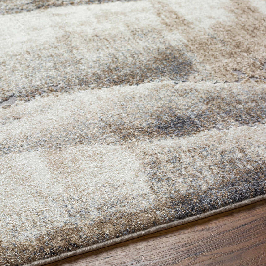 Close up of the Banji Abstract Waves Area Rug showing beige, gray, and brown tones. Texture