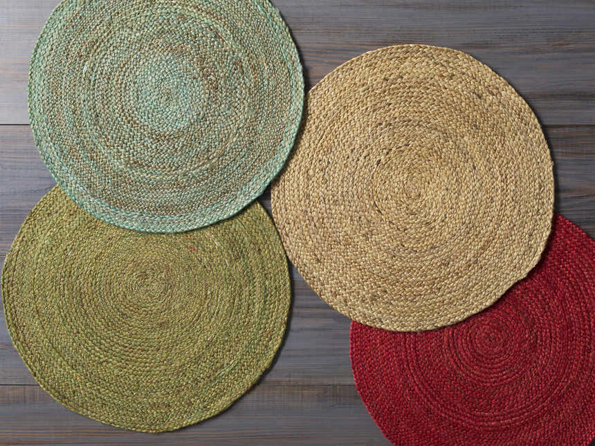 Close-up of Barksdale Green Hand Woven Jute rugs in charcoal, mint, green, tan, and red colors showing natural fiber texture. Styleshot