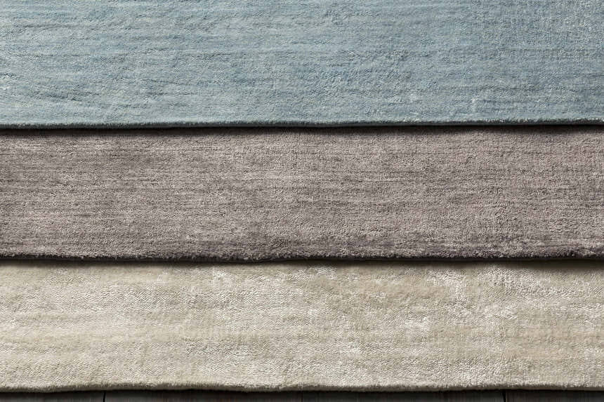Close-up of Barree Area Carpet showing its white, gray, and blue hues and soft, hand-loomed viscose texture. Styleshot