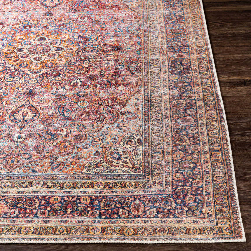 Close up of the Belison Washable Area Rug. Farmhouse style with traditional floral pattern in red, orange, and blue tones. Front