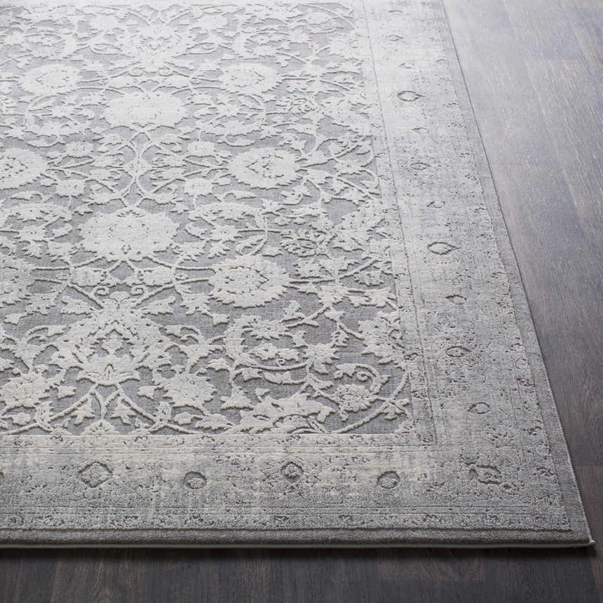 Close-up of the Benavides Gray Updated Traditional Tibetan Rug showing floral pattern and charcoal, gray, and ivory colors. Front