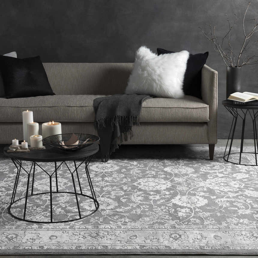 Living room scene with gray sofa, candles, and the Benavides Gray Updated Traditional Tibetan Rug. Roomscene-Rectangle