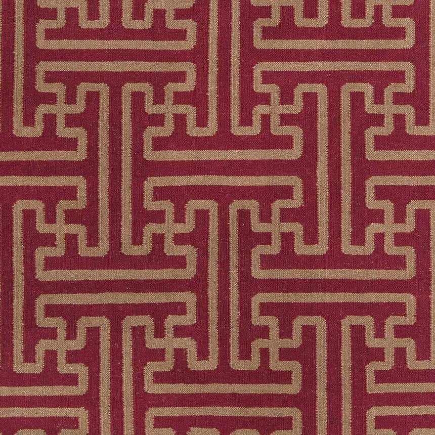 Close-up of Bentonville Area Carpet. Hand-woven wool rug with a geometric tan pattern on a brick red background. Swatch