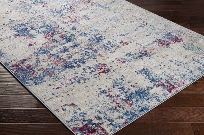 Close-up of the Bergvliet Area Rug. Contemporary style with blue, burgundy, cream, and light gray abstract pattern. Corner
